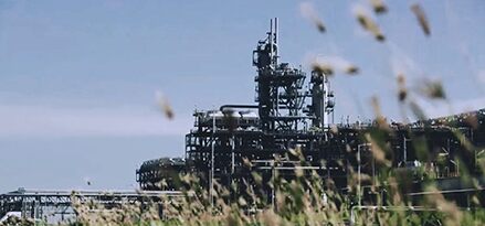 Refinery with grass in foreground