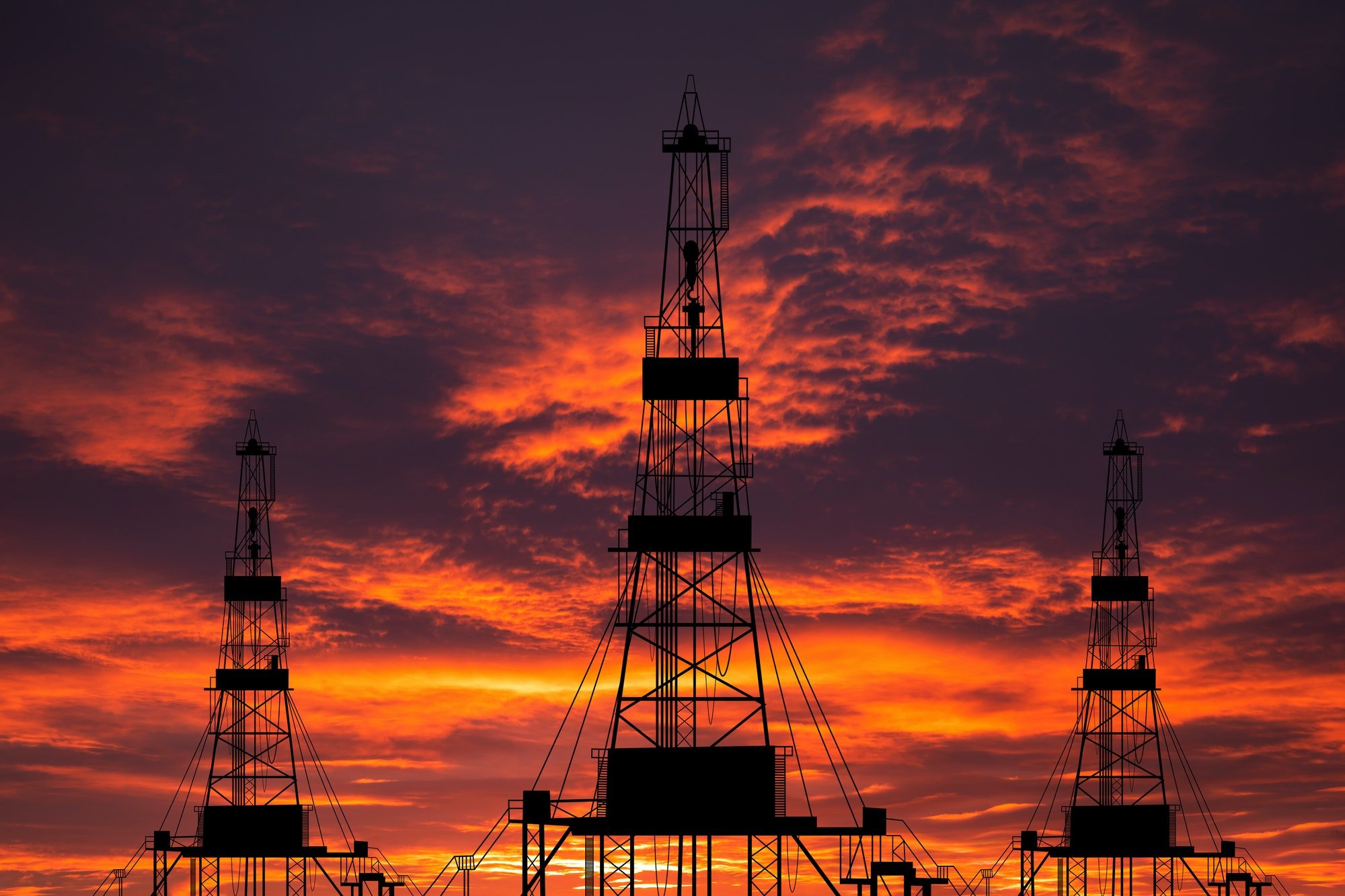 Oil derricks at sunset