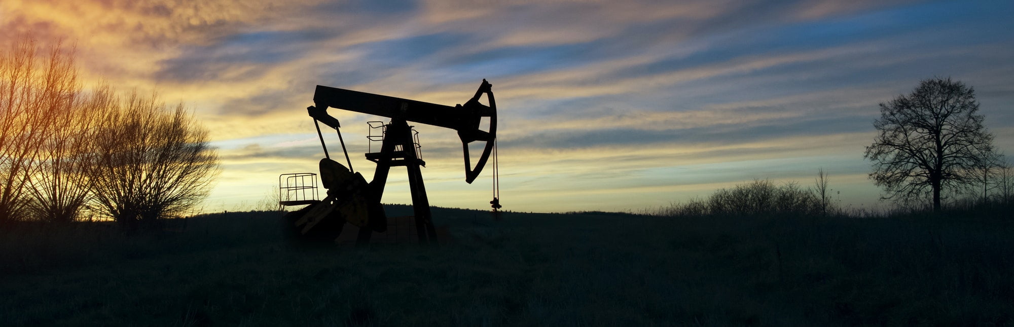 Pump jack operating at dusk